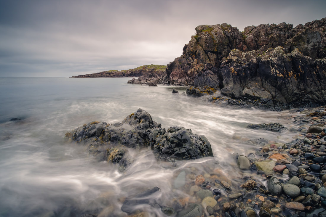 Waves swirling round a rock on the shingle beach at Fascadale Bay | Ardnamurchan Scotland | Steven Marshall Photography