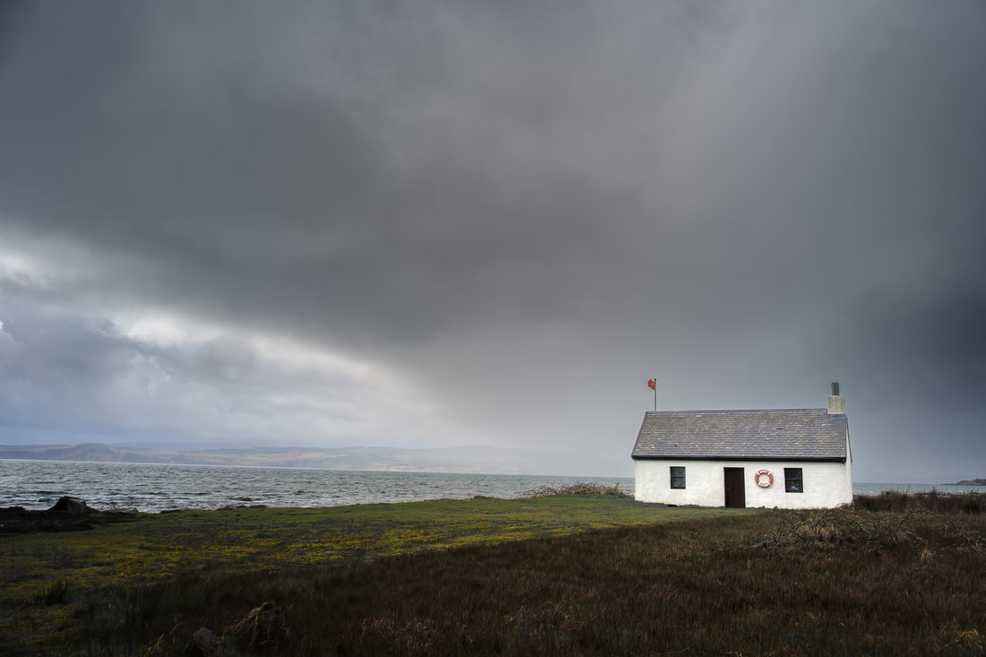 Photographic print of Shore Cottage at Kilchoan under a grey, storm laden sky. Image of Ardnamurchan on the West Highland Peninsulas, Scotland.
