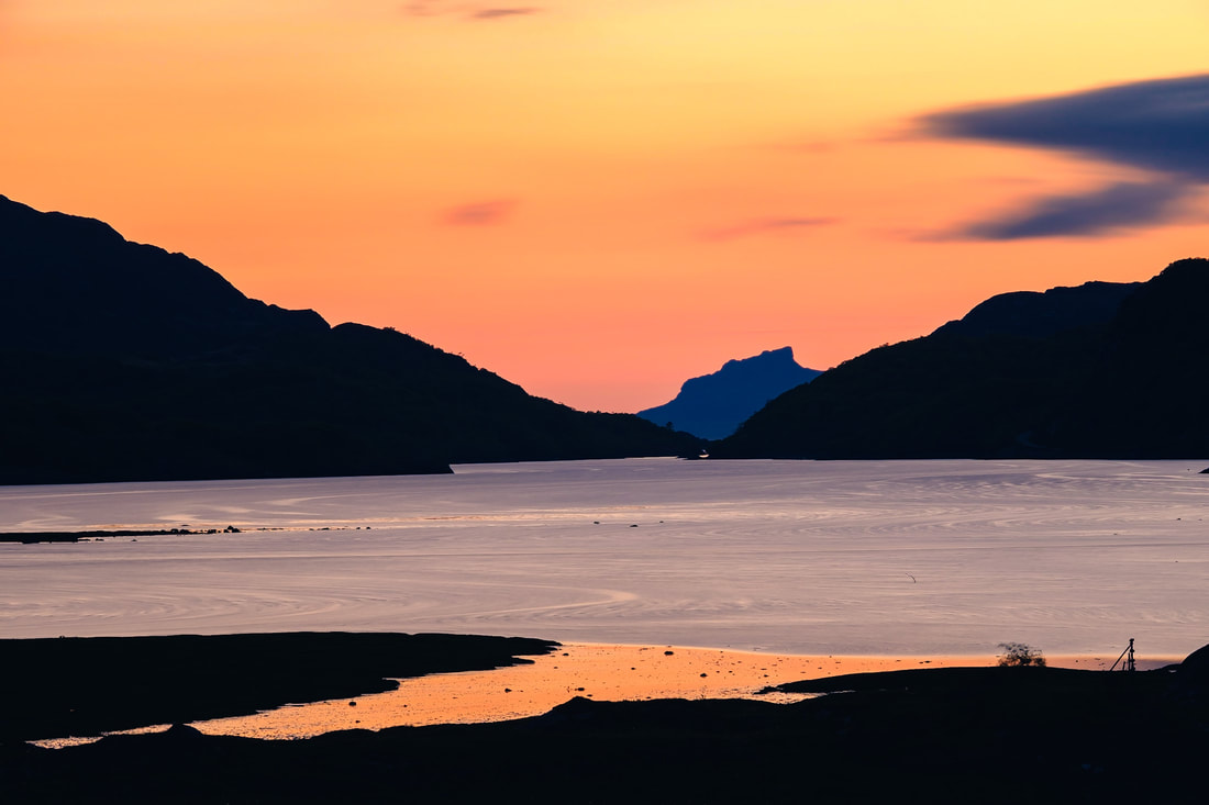 An Sgurr on the Isle of Eigg sitting beyond the North Channel of Loch Moidart beneath an orange sky | Moidart Scotland | Steven Marshall Photography
