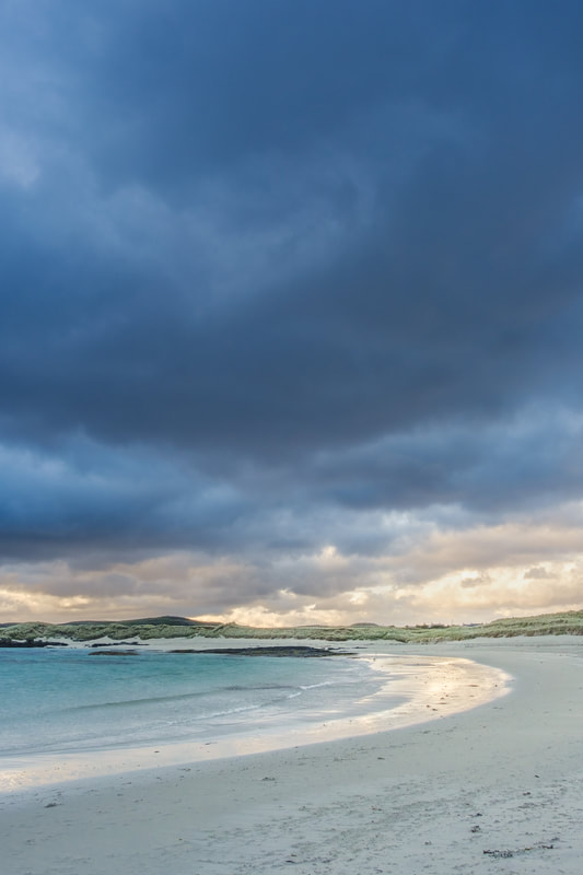 Dark storm clouds gathering over Sanna bay and beach with golden light on the sand | Ardnamurchan Scotland | Steven Marshall Photography