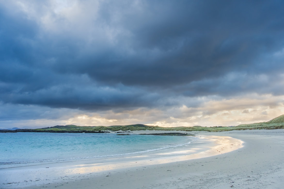 Dark storm clouds gathering over Sanna bay and beach with golden light on the sand | Ardnamurchan Scotland | Steven Marshall Photography