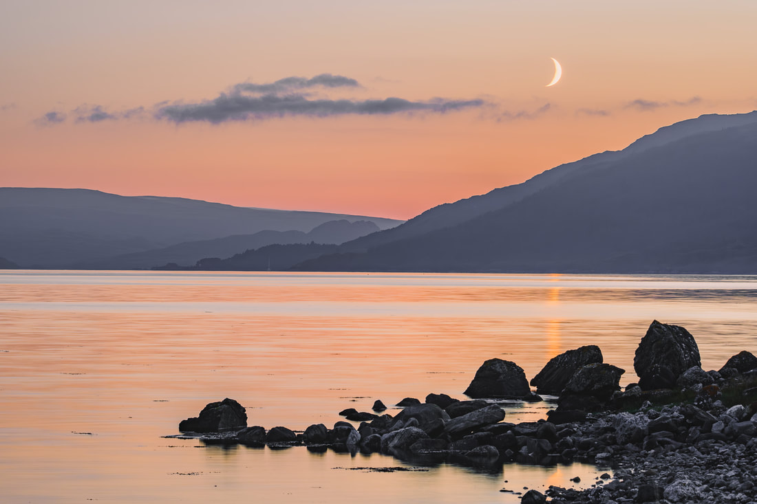 A waxing crescent moon above Loch Sunart during an orange sunset | Sunart Scotland | Steven Marshall Photography