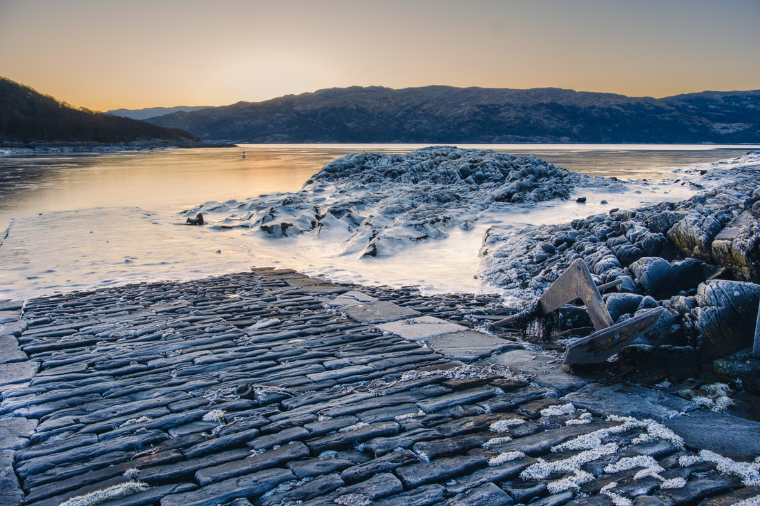 The stone jetty in Salen Bay with ice on rocks and a frozen Loch Sunart | Ardnamurchan Scotland | Steven Marshall Photography