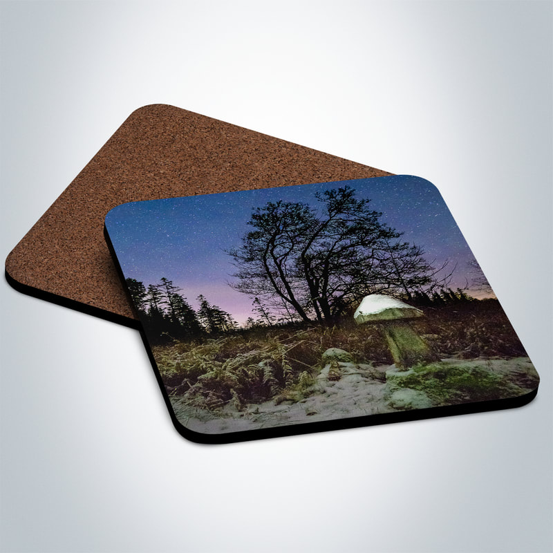 Souvenir photo coaster featuring an image of one of the carved wooden mushrooms that can be found in the woods at The Bay of Flies, capped with snow and under a clear and cold night sky | Ardnamurchan Scotland