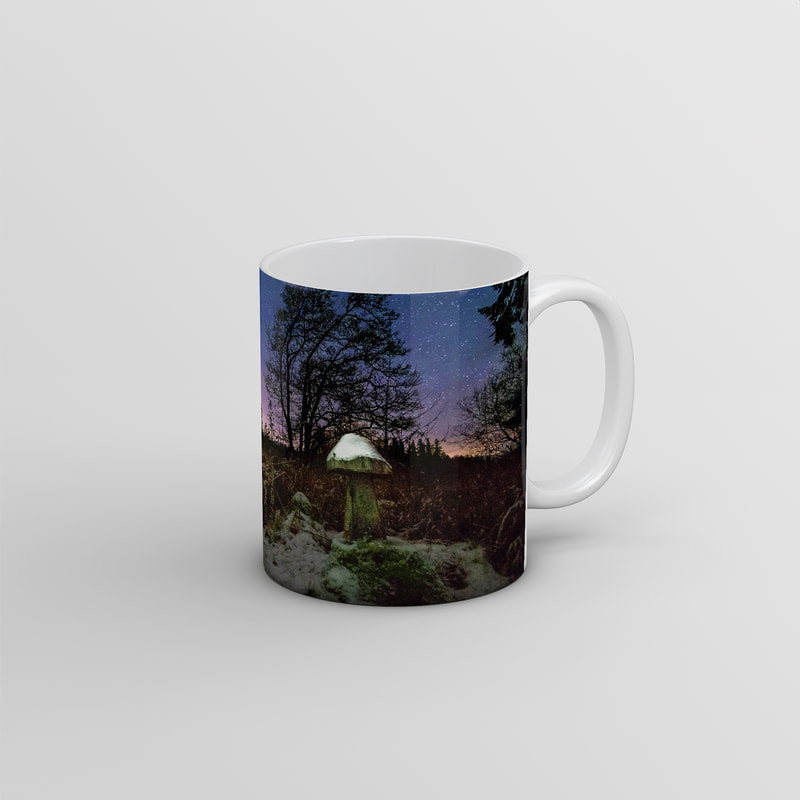 Souvenir photo mug featuring an image of one of the carved wooden mushrooms that can be found in the woods at The Bay of Flies, capped with snow and under a clear and cold night sky | Ardnamurchan Scotland