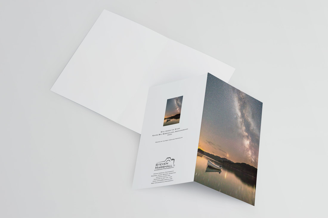 An A6 greeting card featuring a small day boat on the water of Kentra Bay by the stone jetty at Gobshealach with the Milky Way soaring up into the night sky and Mars to the left above the horizon | Ardnamurchan Scotland