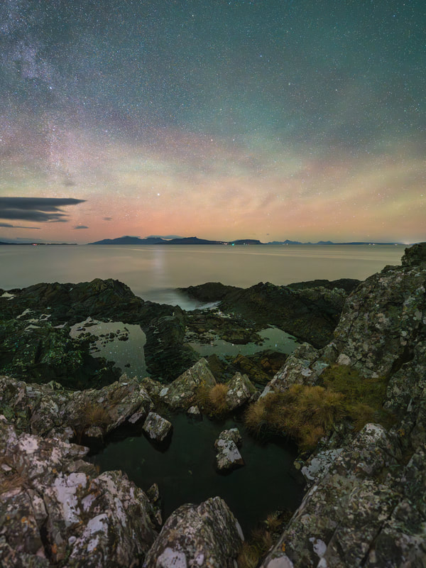 A night sky view across the sea to the Small Isles from Fascadale with airglow and stars in the sky | Ardnamurchan Scotland | Steven Marshall Photography