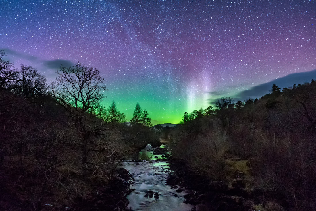 A view from the Ivy Bridge at Kinlochaline with Northern Lights beyond the hills from where the River Aline flows | Morvern Scotland