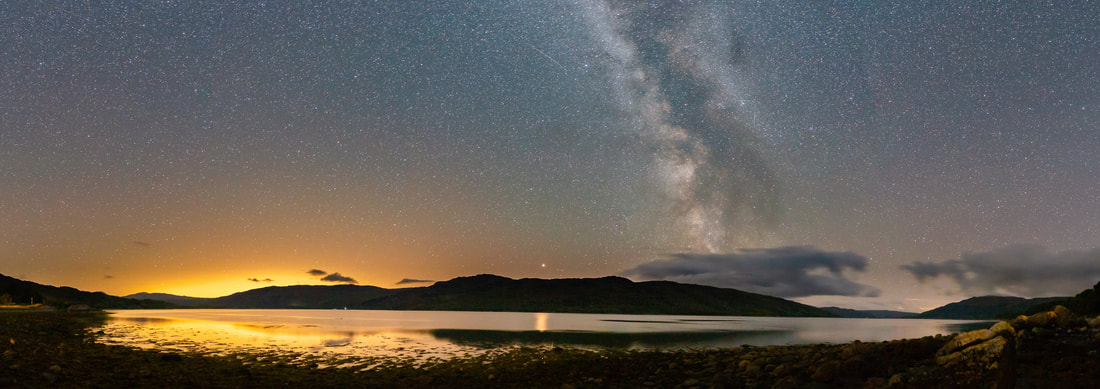 A panoramic view of the night sky and the Milky Way above Loch Sunart at Resipole with Mars reflecting its light on the surface of the Loch | Ardnamurchan Scotland
