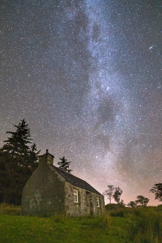 A small bothy by the shore of Loch Linnhe at Kilmalieu under the Milky Way and a night sky full of stars | Ardgour Scotland