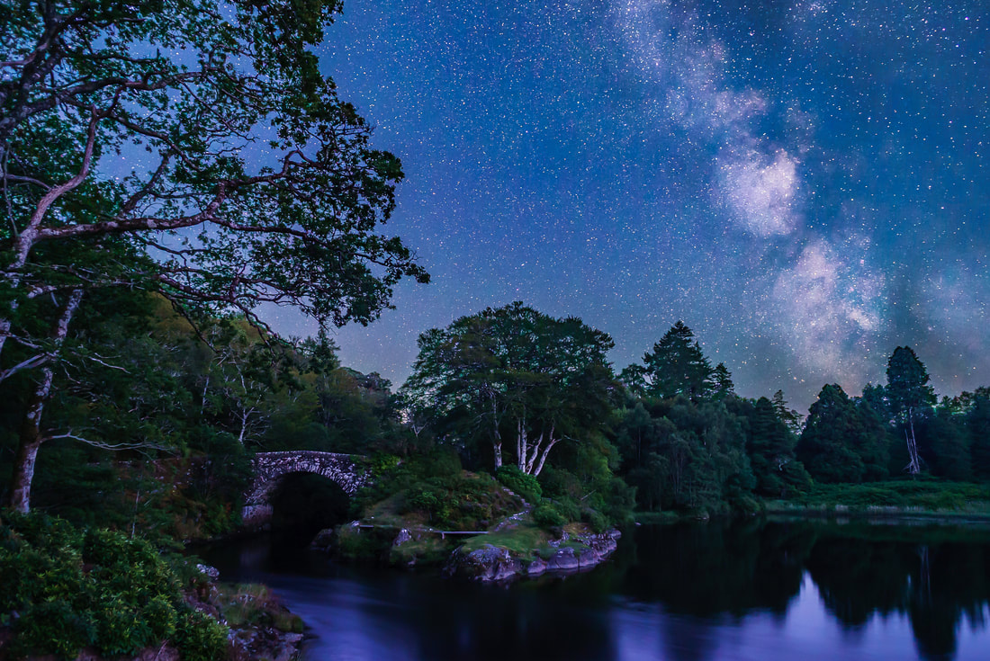 The cloudy core of our galaxy, the Milky Way, soaring above the old bridge that crosses the River Shiel to link Moidart and Ardnamurchan | Scotland