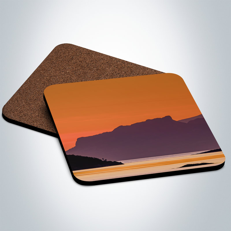 Souvenir photo coaster featuring an image An Sgurr, the prominent peak on the Isle Eigg, viewed against an orange sunset sky through the gap at the entrance to Kentra Bay | Ardnamurchan Scotland
