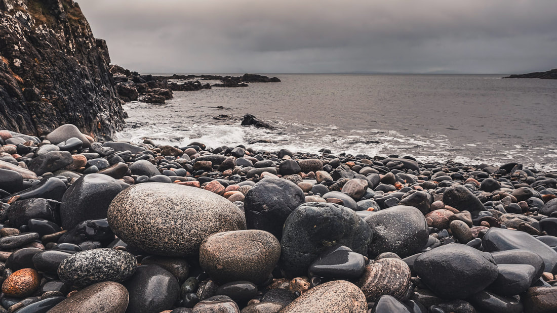 Rain-soaked round boulders on the beach at Fascadale Bay on a grey day | Ardnamurchan, Scotland | Steven Marshall Photography